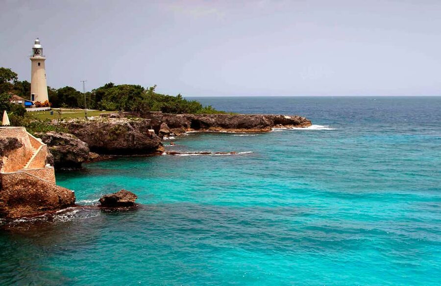 From Montego Bay: Negril Beach & Rick's Cafe Sunset Day Trip - Margaritaville gives the beach stop a social edge