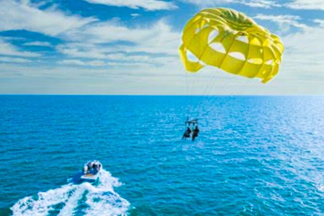 Parasailing above Turquoise Ocean Waters in Montego Bay - Coming back down and enjoying the water